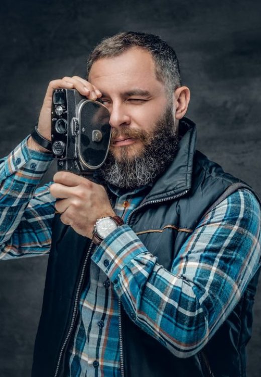 bearded-middle-age-male-holds-vintage-8-mm-video-camera-.jpg
